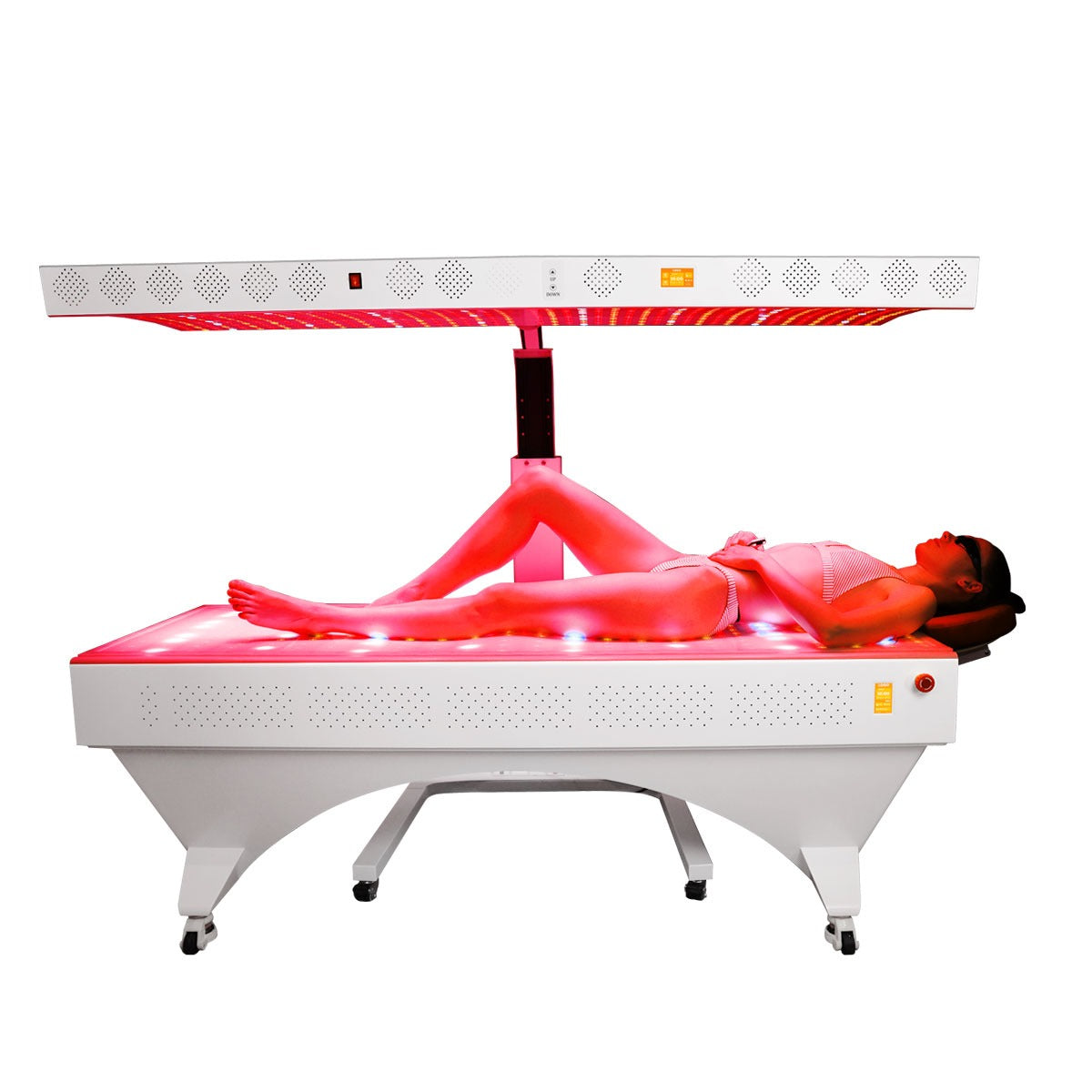 Professional red light therapy bed with adjustable upper panel, white metal frame and the user lying in a bikini.