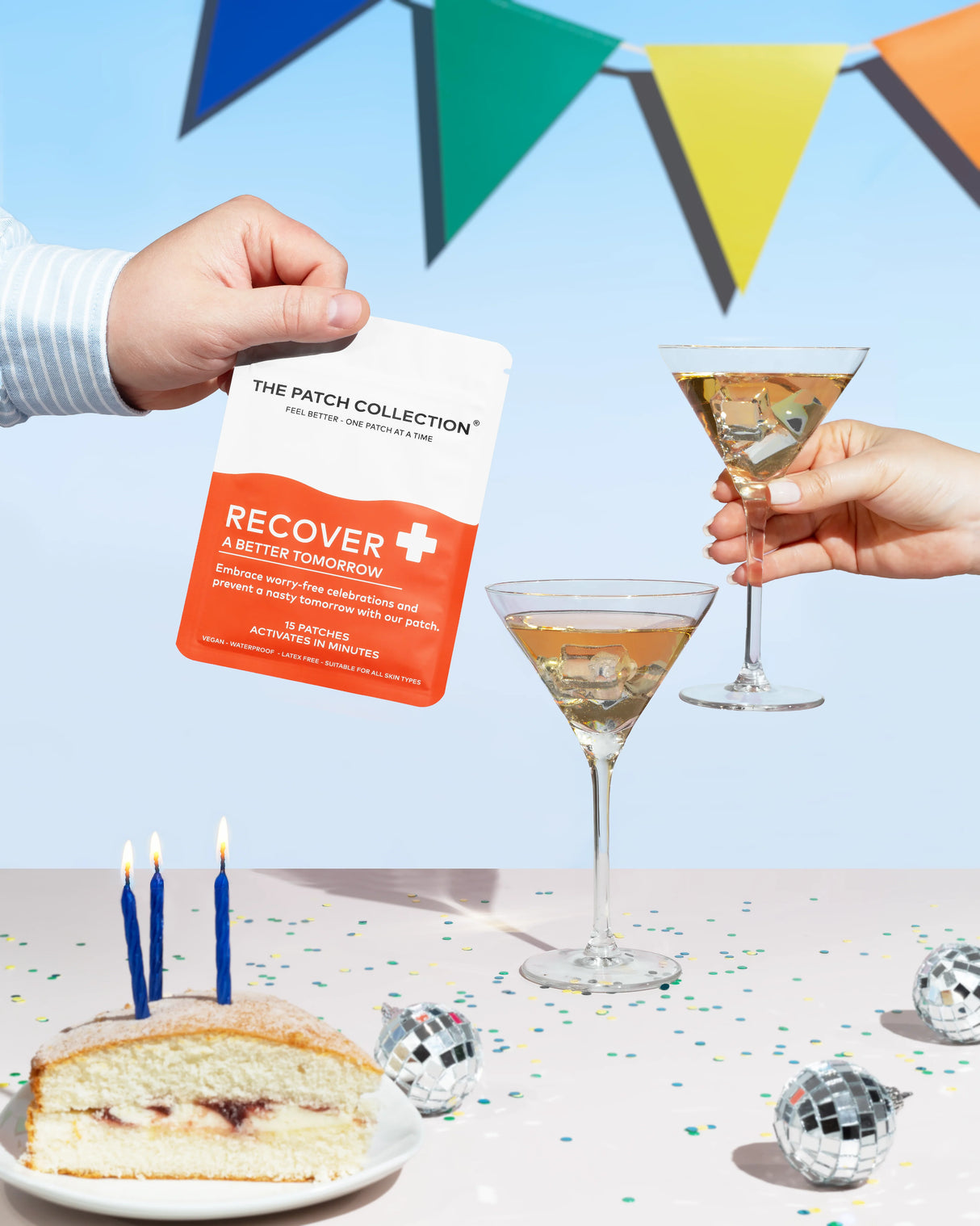 Hand holding a pack of "Recover Patches" in front of a festive background with drinks and cake.