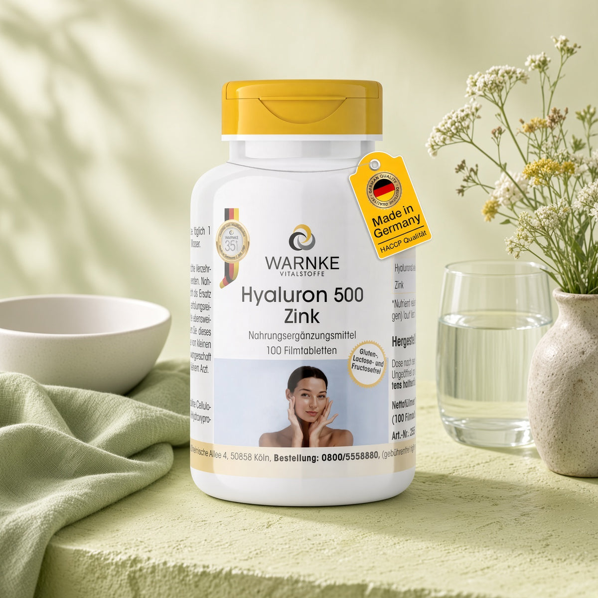 Hyaluron 500 + Zinc in white container with yellow lid, 100 film-coated tablets, with a woman showing her skin.