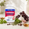 Candidase® Extra Strength food supplement in a white bottle with a blue label, surrounded by garlic, grapes and herbs.