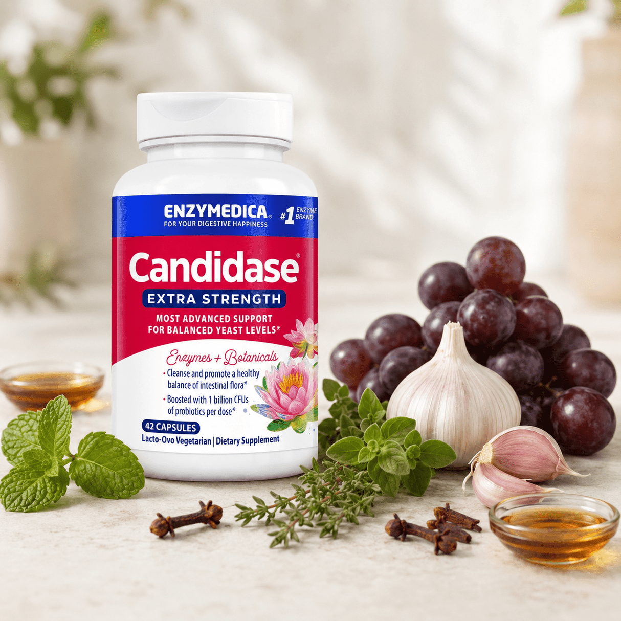 Candidase® Extra Strength food supplement in a white bottle with a blue label, surrounded by garlic, grapes and herbs.