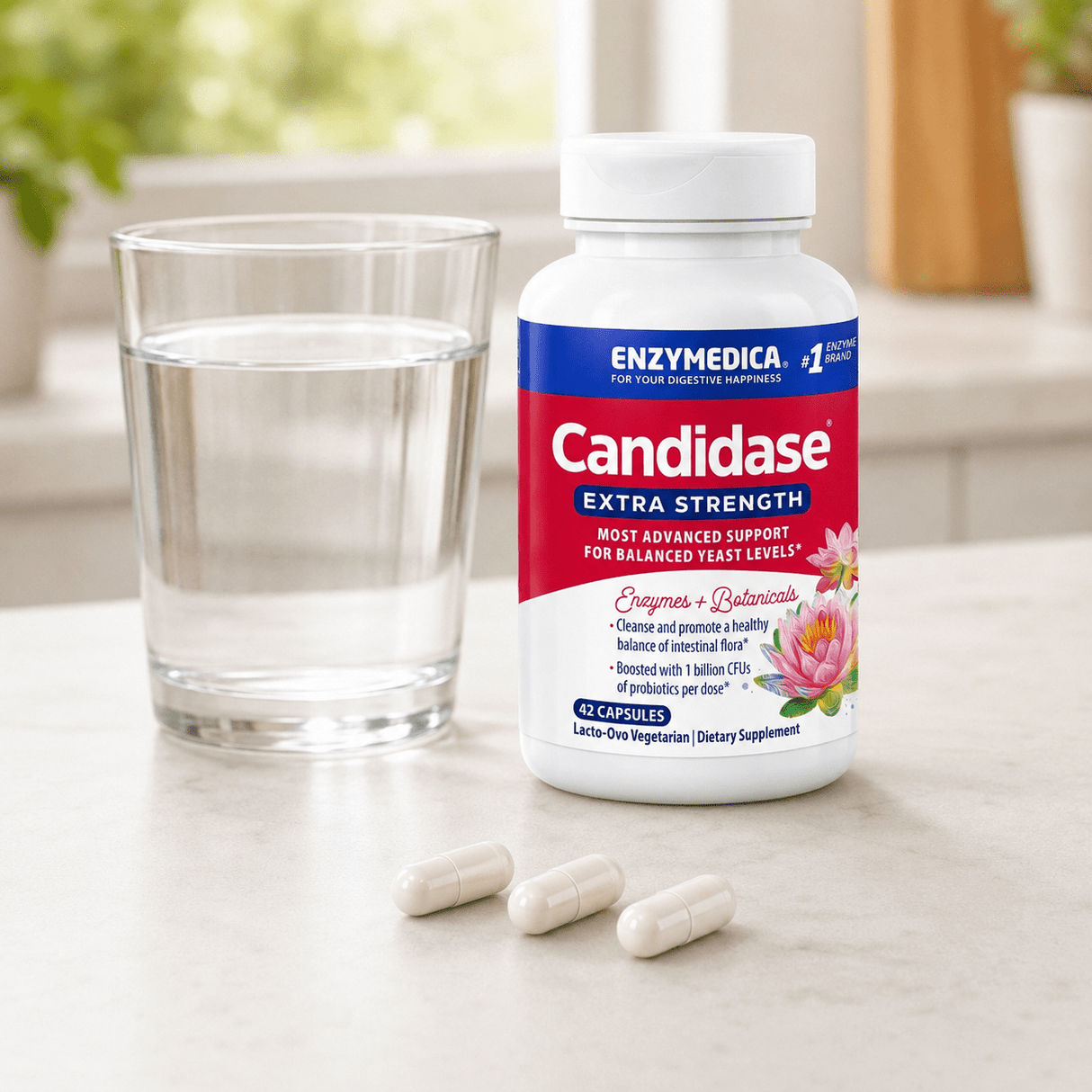 Candidase® Extra Strength in white container, with three capsules near a glass of water.