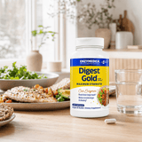 Digest Gold® with ATPro® in a white container is on a table, surrounded by a plate of fish, salad and bread.